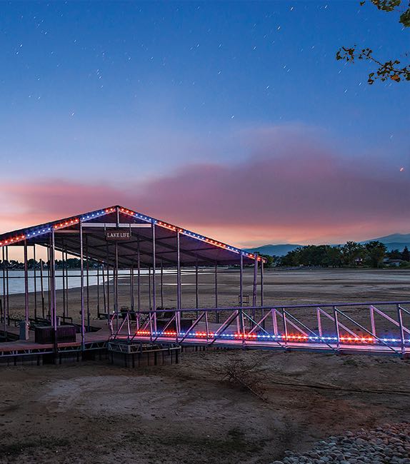 A dock lit with permanent lights at dusk