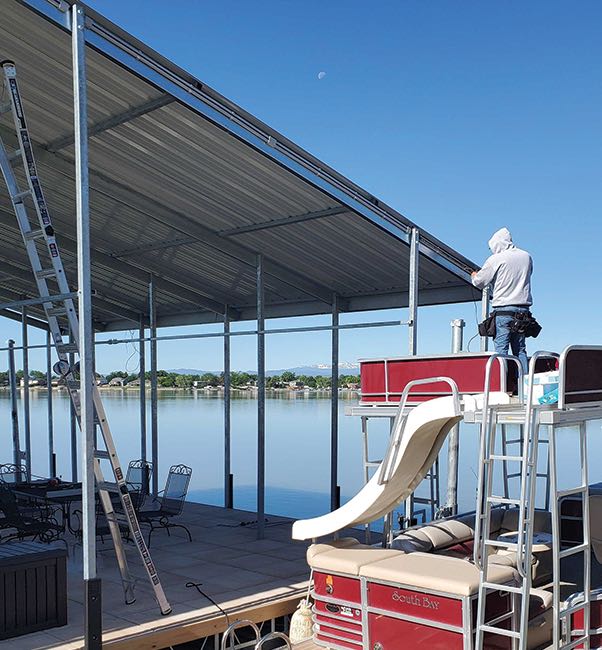 Hanging lights by hand on a dock